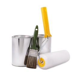 Photo of Cans of paints, brush and roller on white background