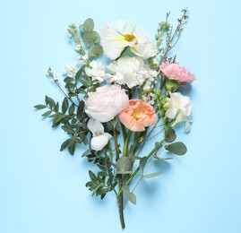 Photo of Different beautiful flowers on light blue background, flat lay