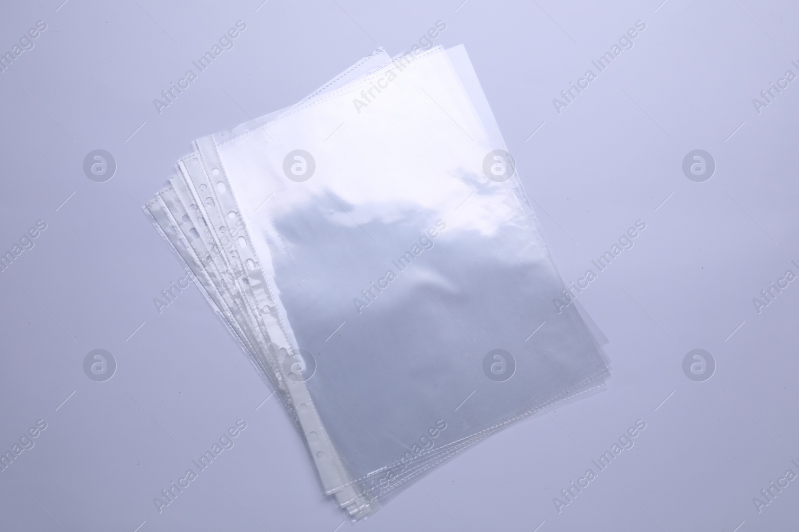 Photo of Empty punched pockets isolated on white, top view