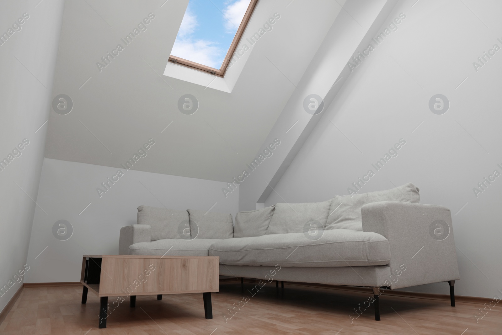 Photo of Attic room interior with slanted ceiling and furniture