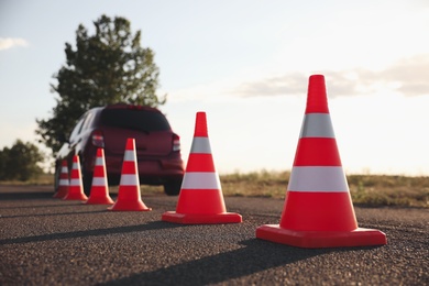 Traffic cones near car outdoors. Driving school exam