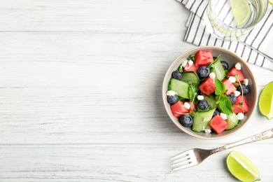 Photo of Delicious salad with watermelon served on white wooden table, flat lay. Space for text