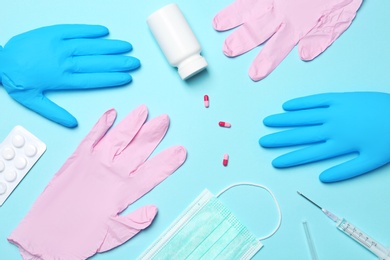Photo of Flat lay composition with medical gloves on color background