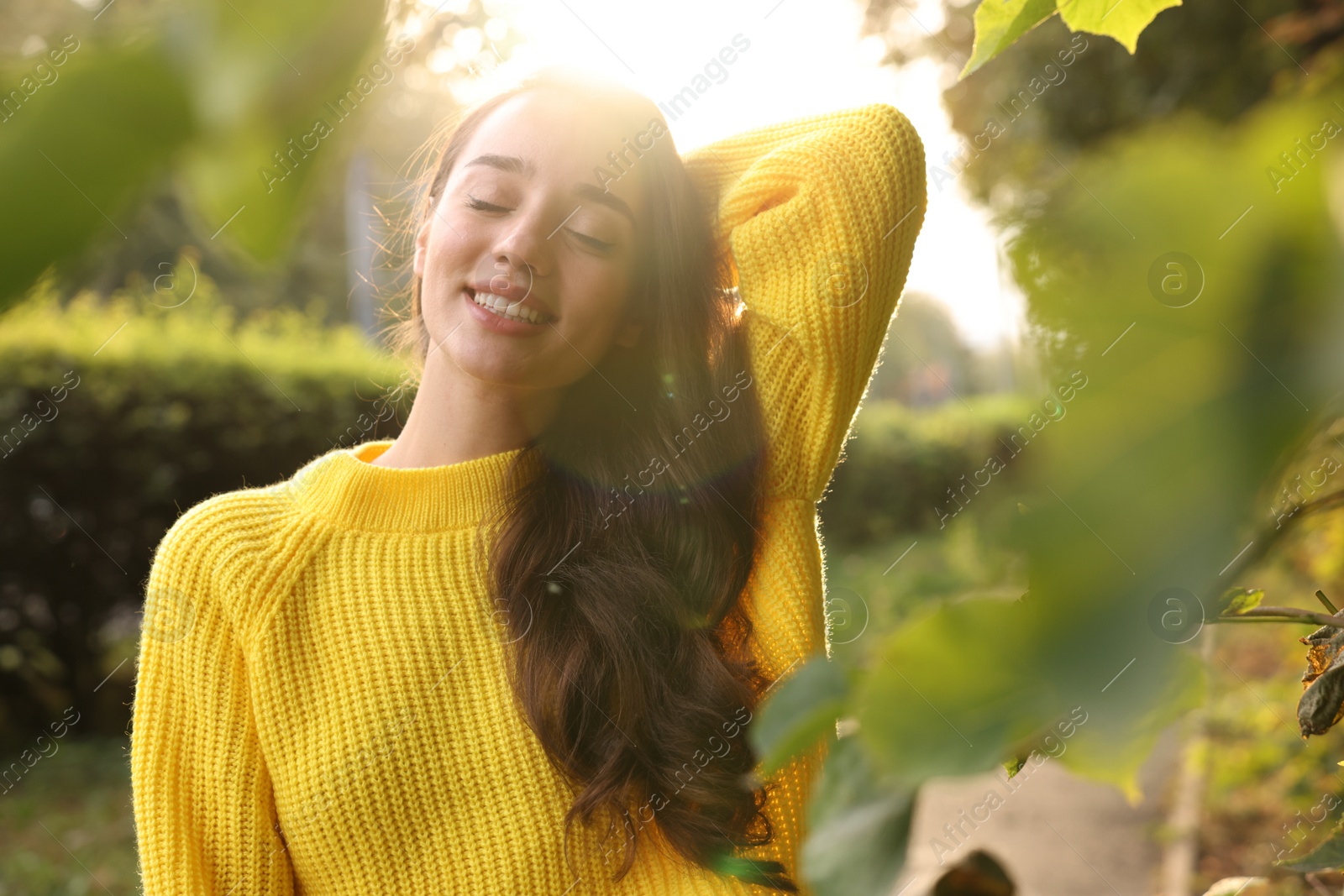 Photo of Beautiful young woman in stylish warm sweater on sunny day