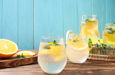 Photo of Delicious refreshing citrus drink on wooden table