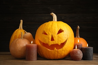 Photo of Composition with pumpkin head on black background. Jack lantern - traditional Halloween decor