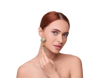 Young woman massaging her face with jade roller on white background