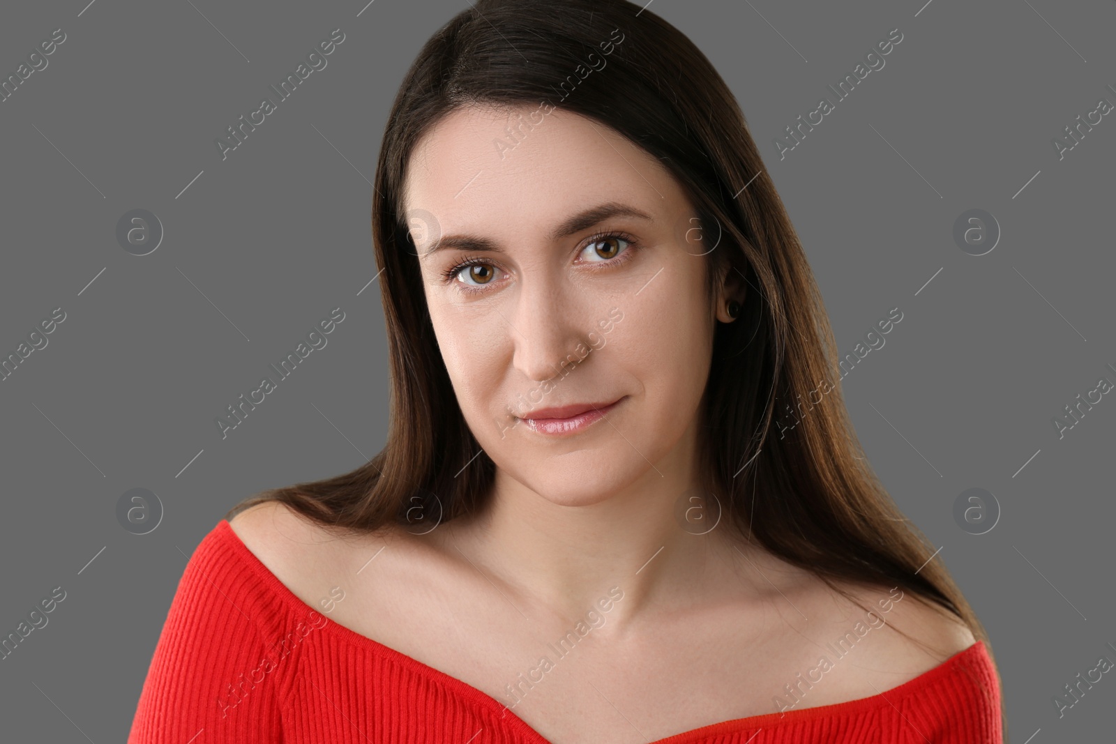 Photo of Portrait of beautiful young woman on grey background