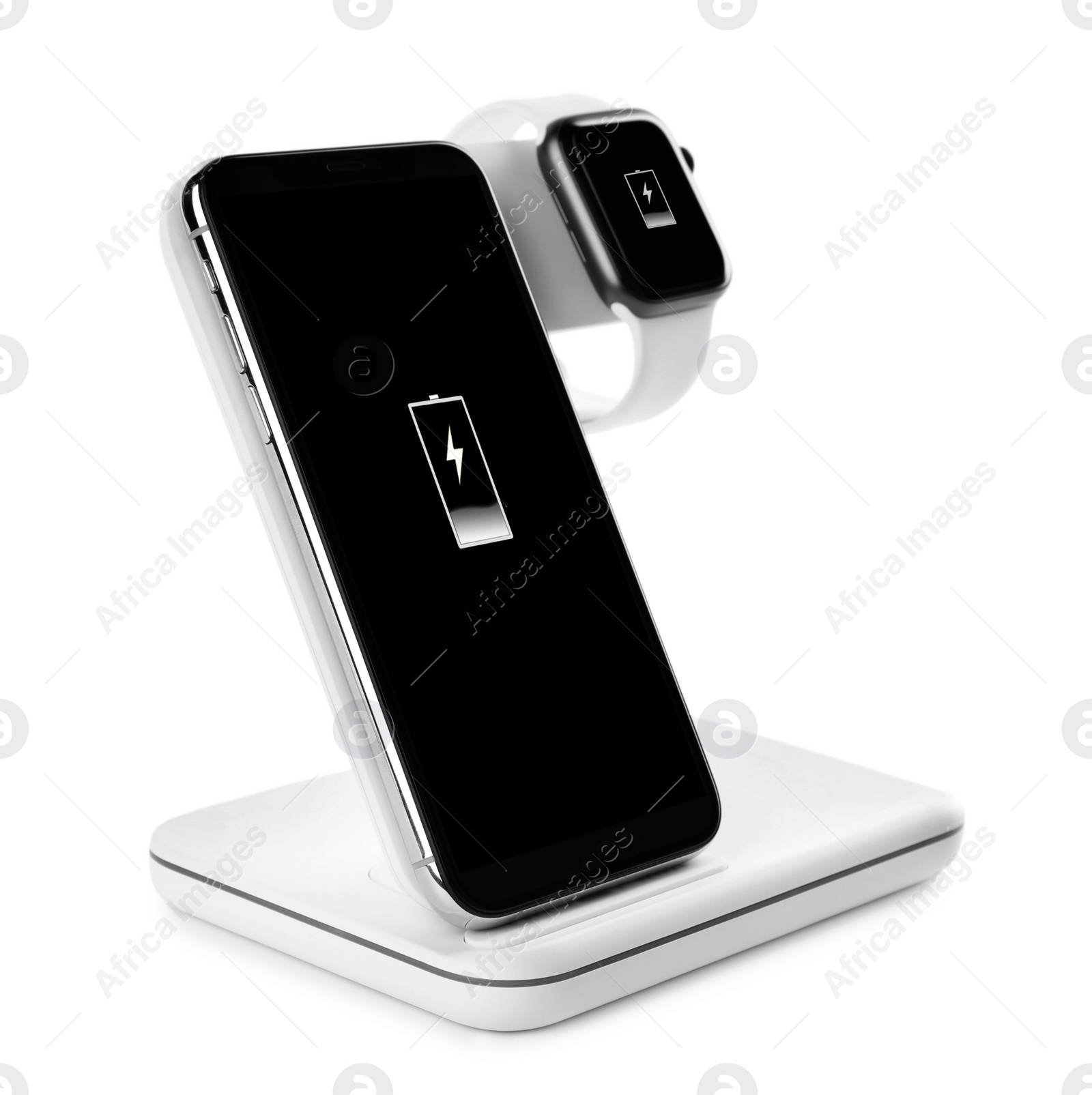 Photo of Mobile phone and smartwatch charging with wireless pad isolated on white