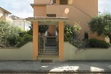 Entrance of residential house with yard on sunny day