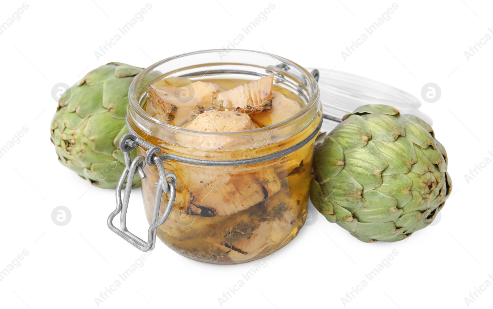 Photo of Open jar of delicious artichokes pickled in olive oil and fresh vegetables on white background