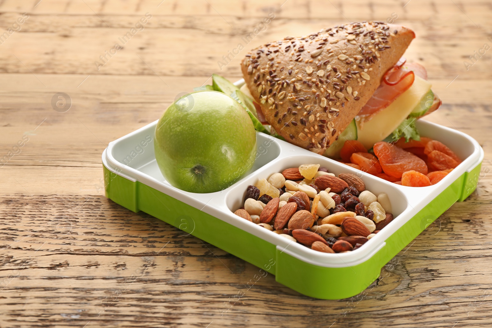 Photo of Lunch box with tasty food on wooden background