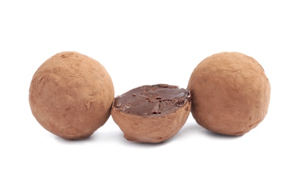 Delicious raw chocolate truffles on white background