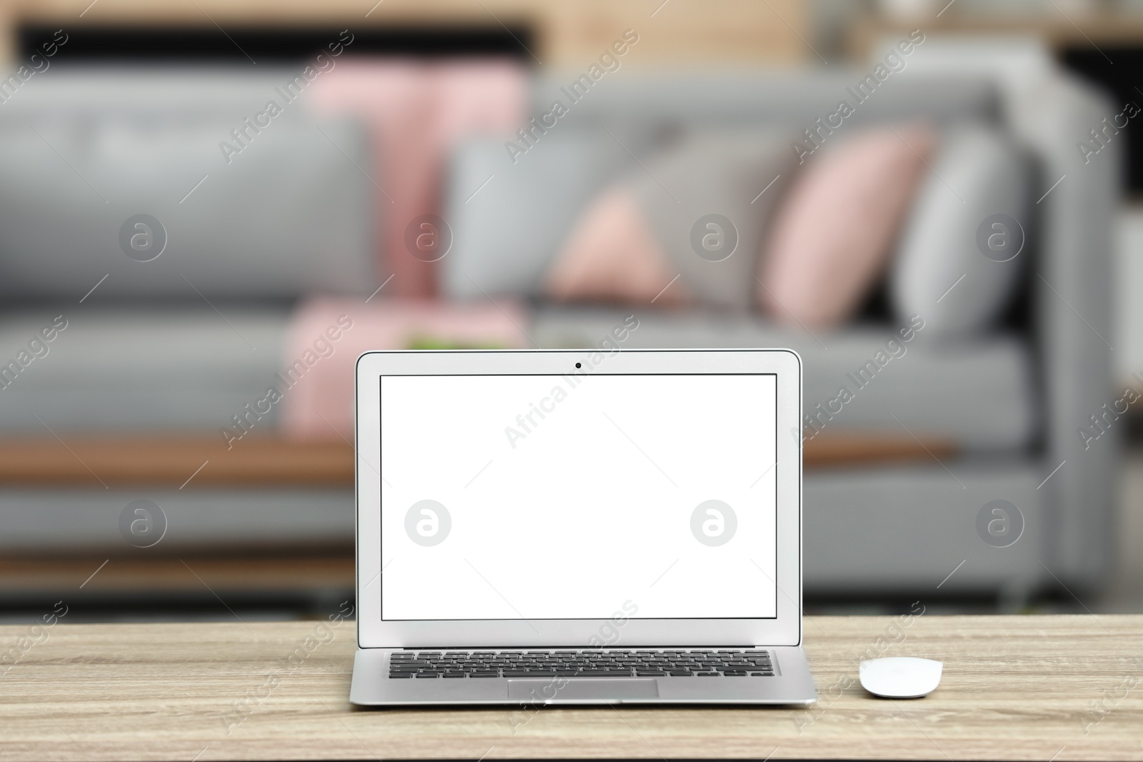 Photo of Laptop with blank screen on table indoors. Space for text