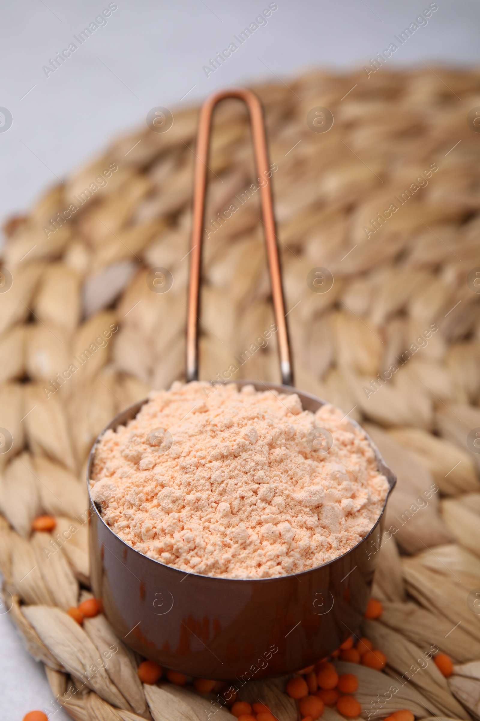 Photo of Organic lentil flour on wicker mat, closeup