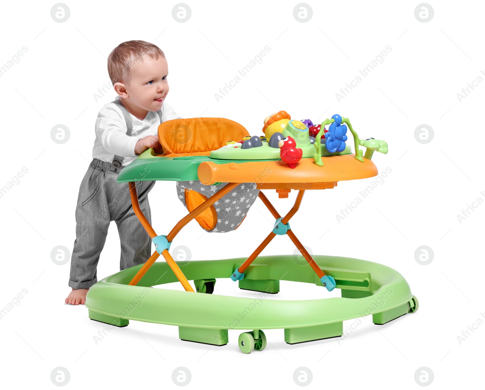 Photo of Cute little boy with baby walker on white background