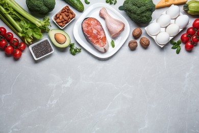 Photo of Flat lay composition with keto diet products on light grey marble table, space for text