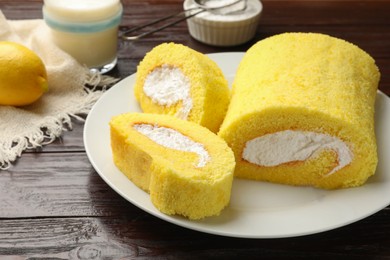 Delicious cake roll on wooden table, closeup