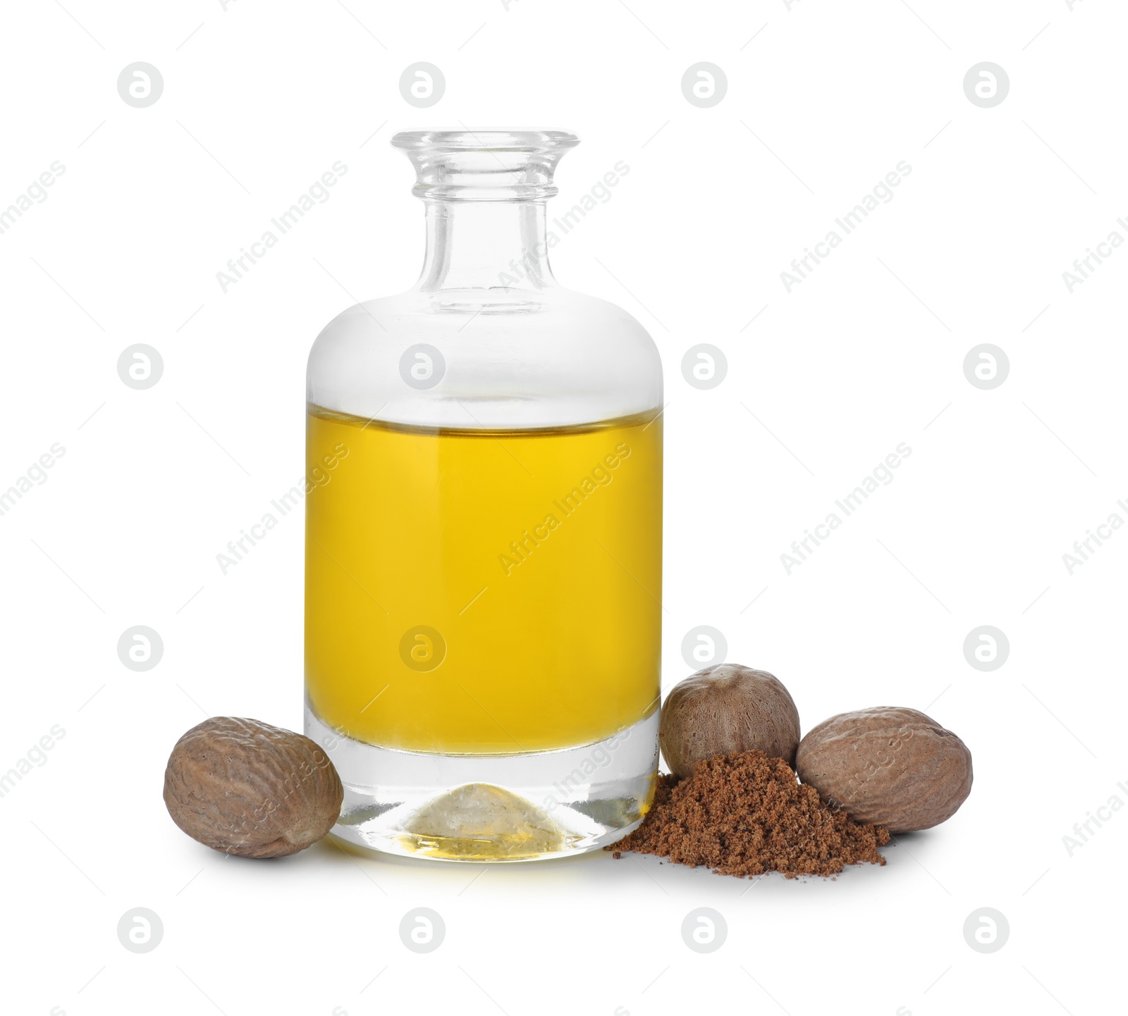 Photo of Bottle of nutmeg oil, nuts and powder on white background