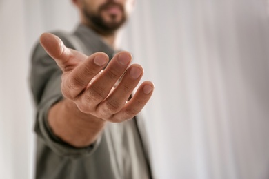 Man giving hand to somebody, closeup with space for text. Help and support concept