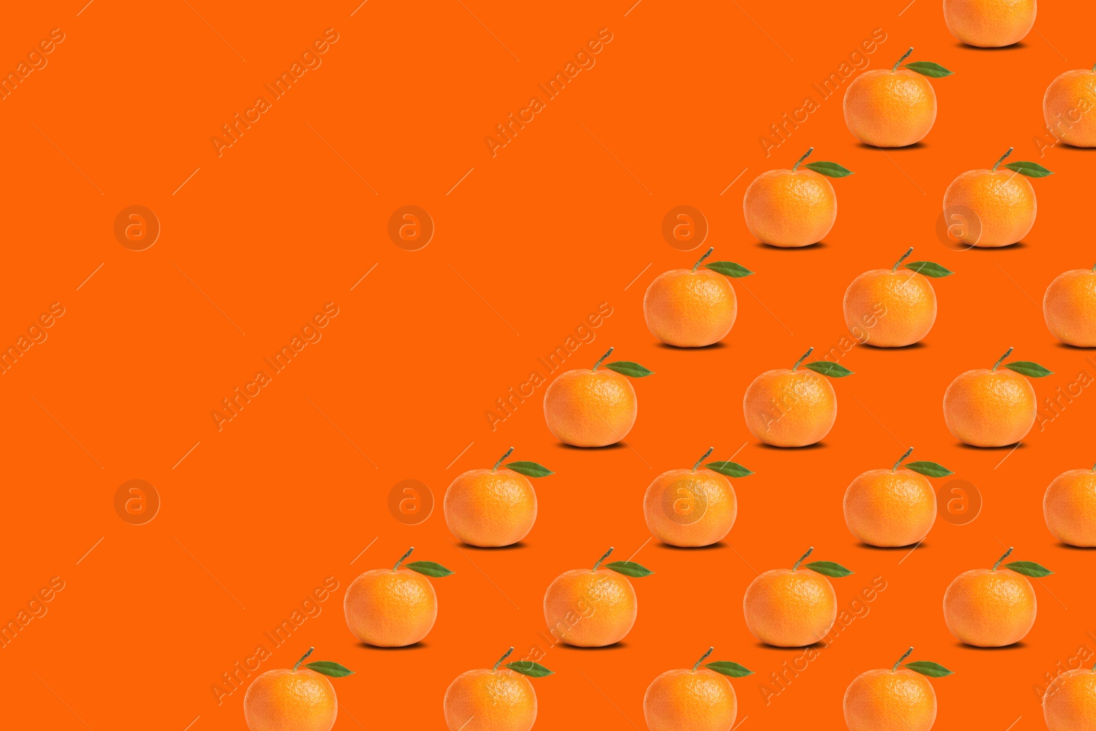 Image of Many fresh ripe tangerines with leaves on orange background, space for text