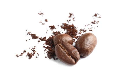 Photo of Coffee grounds and roasted beans on white background