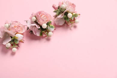 Stylish boutonnieres on pink background, above view. Space for text