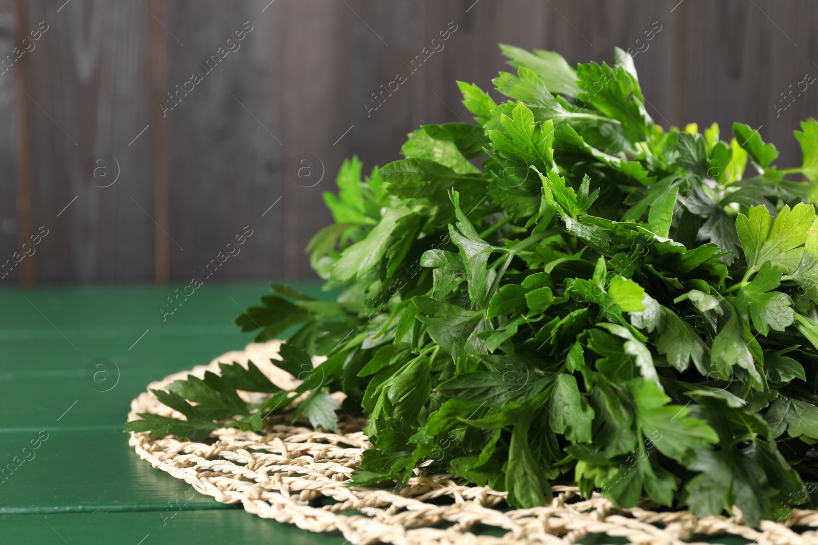 Photo of Fresh green parsley on wooden table, closeup. Space for text