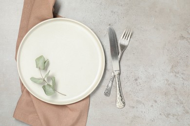 Photo of Setting with beautiful cutlery on textured table, top view. Space for text