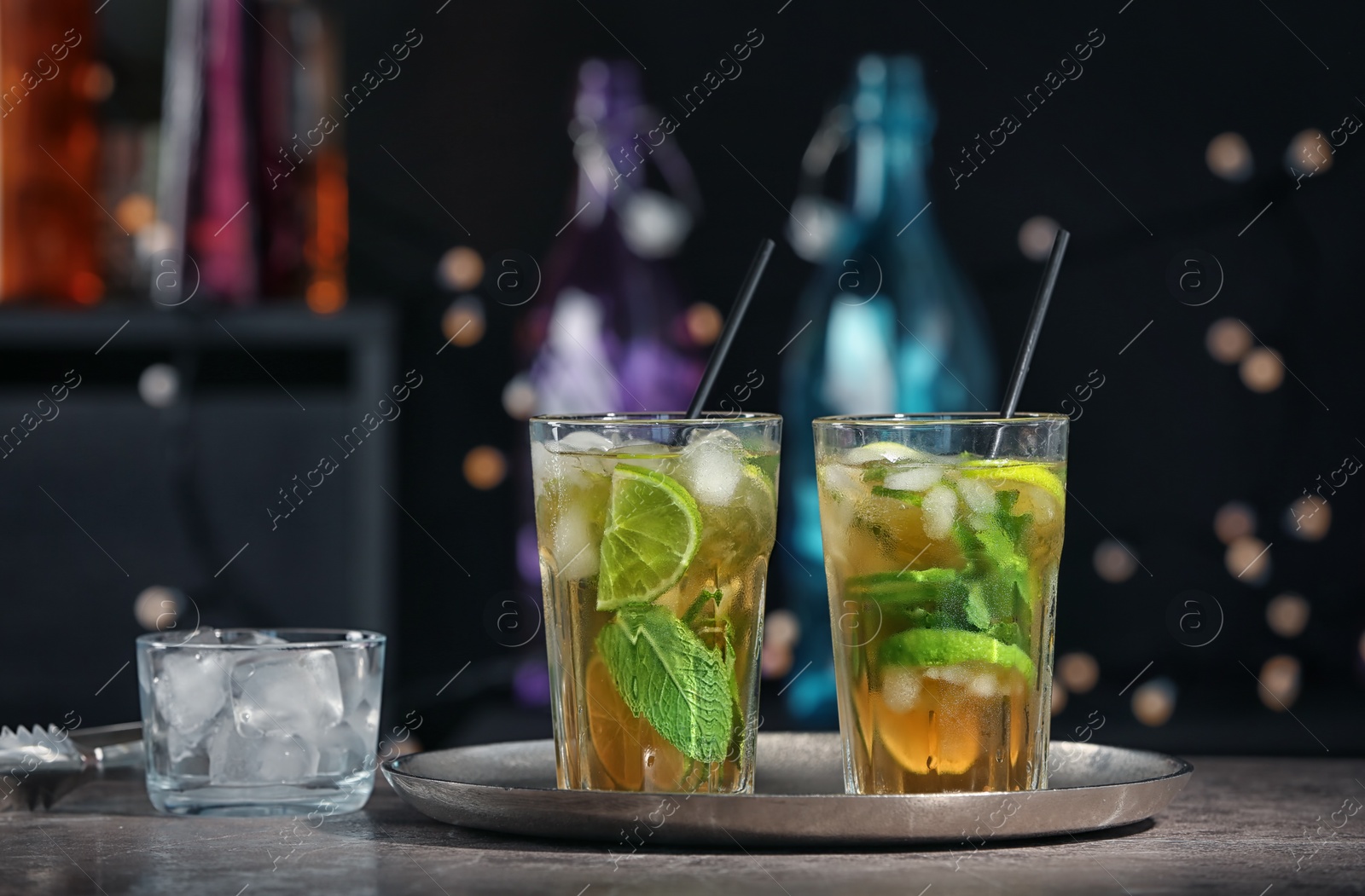 Photo of Delicious mint julep cocktail in glasses on bar counter