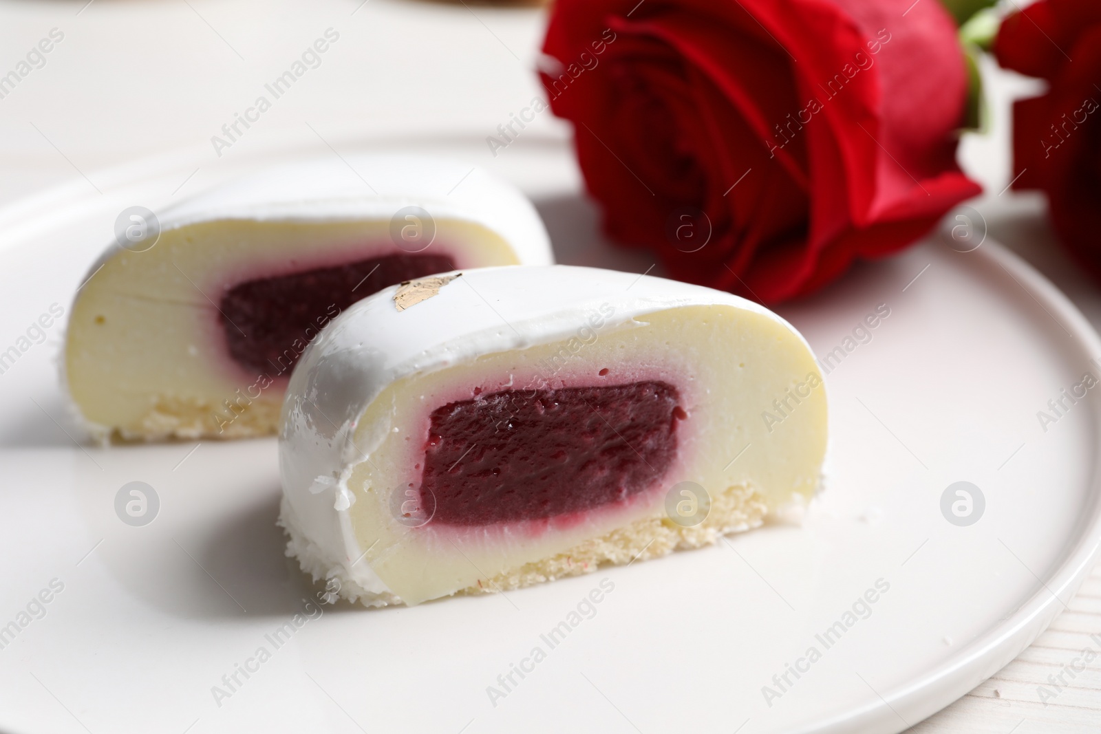 Photo of St. Valentine's Day. Pieces of delicious cake served on table, closeup