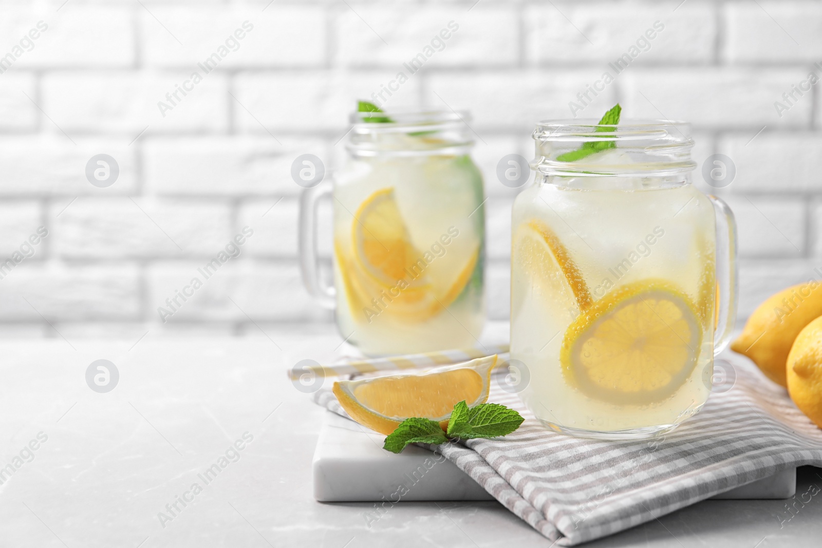 Photo of Mason jars of natural lemonade on table