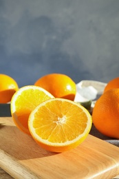 Fresh juicy oranges on wooden cutting board