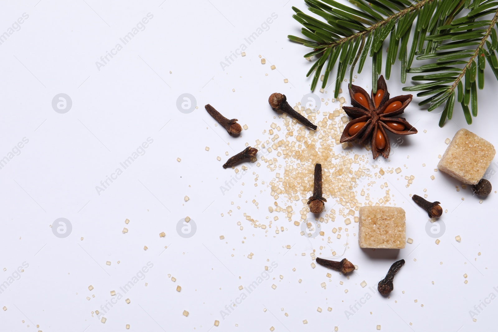 Photo of Different spices and fir branches on white table, flat lay. Space for text