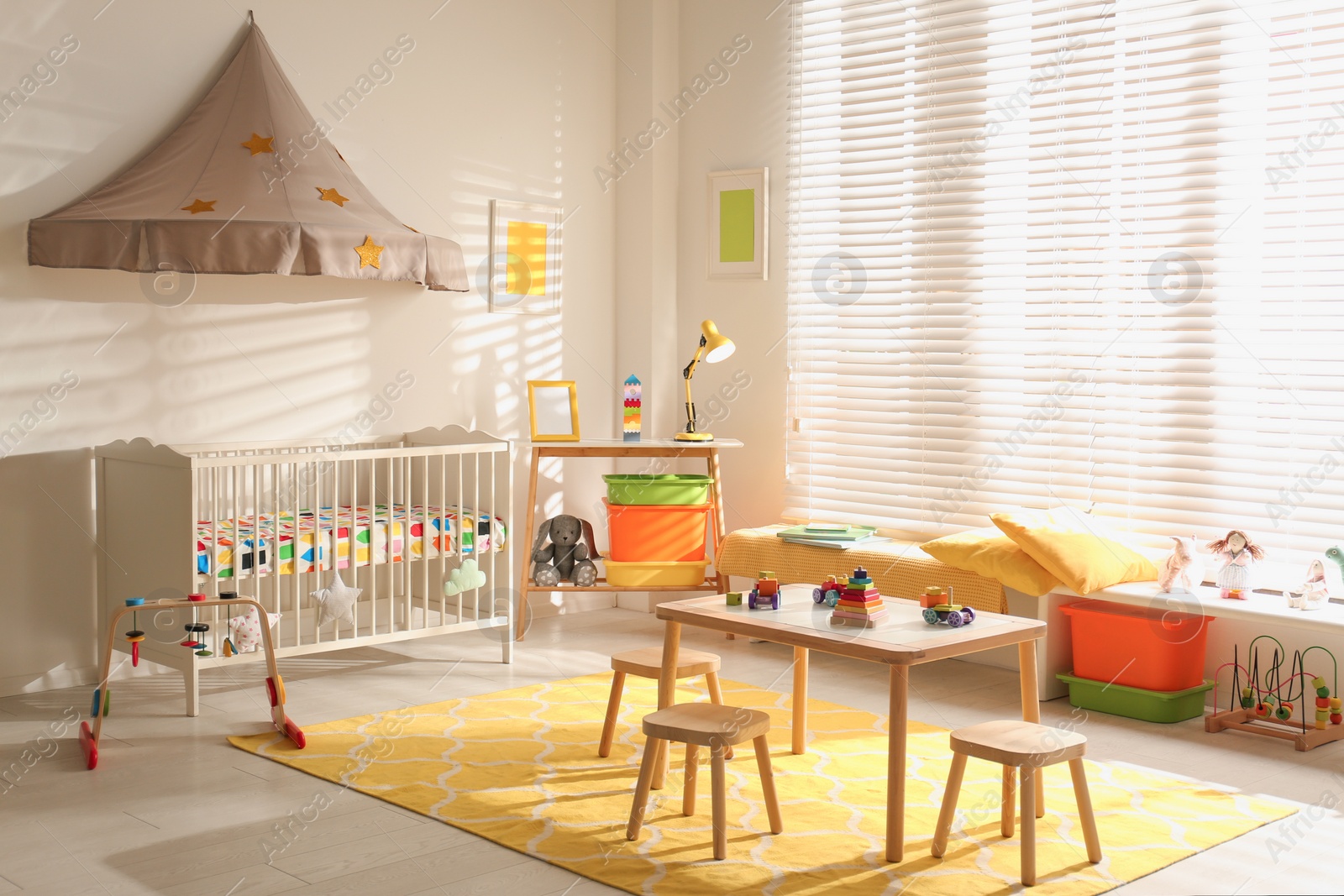 Photo of Cozy baby room interior with comfortable crib