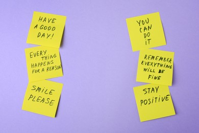 Photo of Paper notes with life-affirming phrases on violet background. Space for text