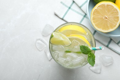 Flat lay composition of delicious lemonade with soda water and mint on light grey table, space for text. Fresh summer cocktail