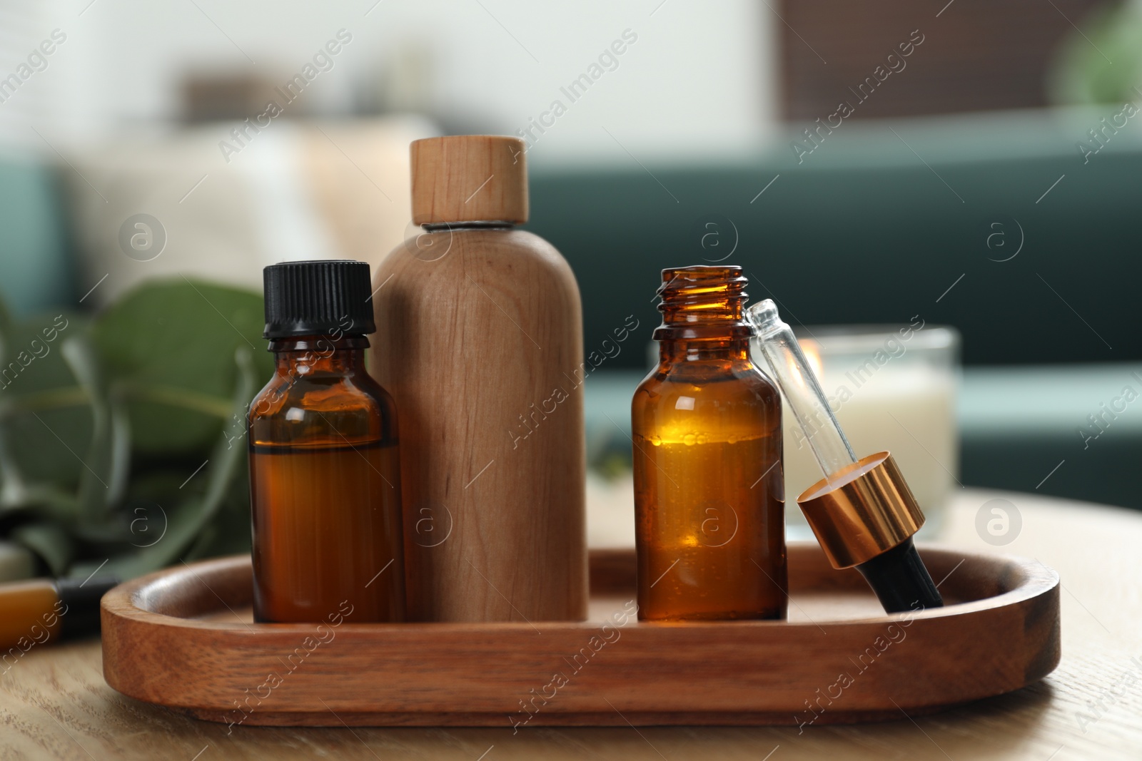 Photo of Aromatherapy. Bottles of essential oil on wooden table