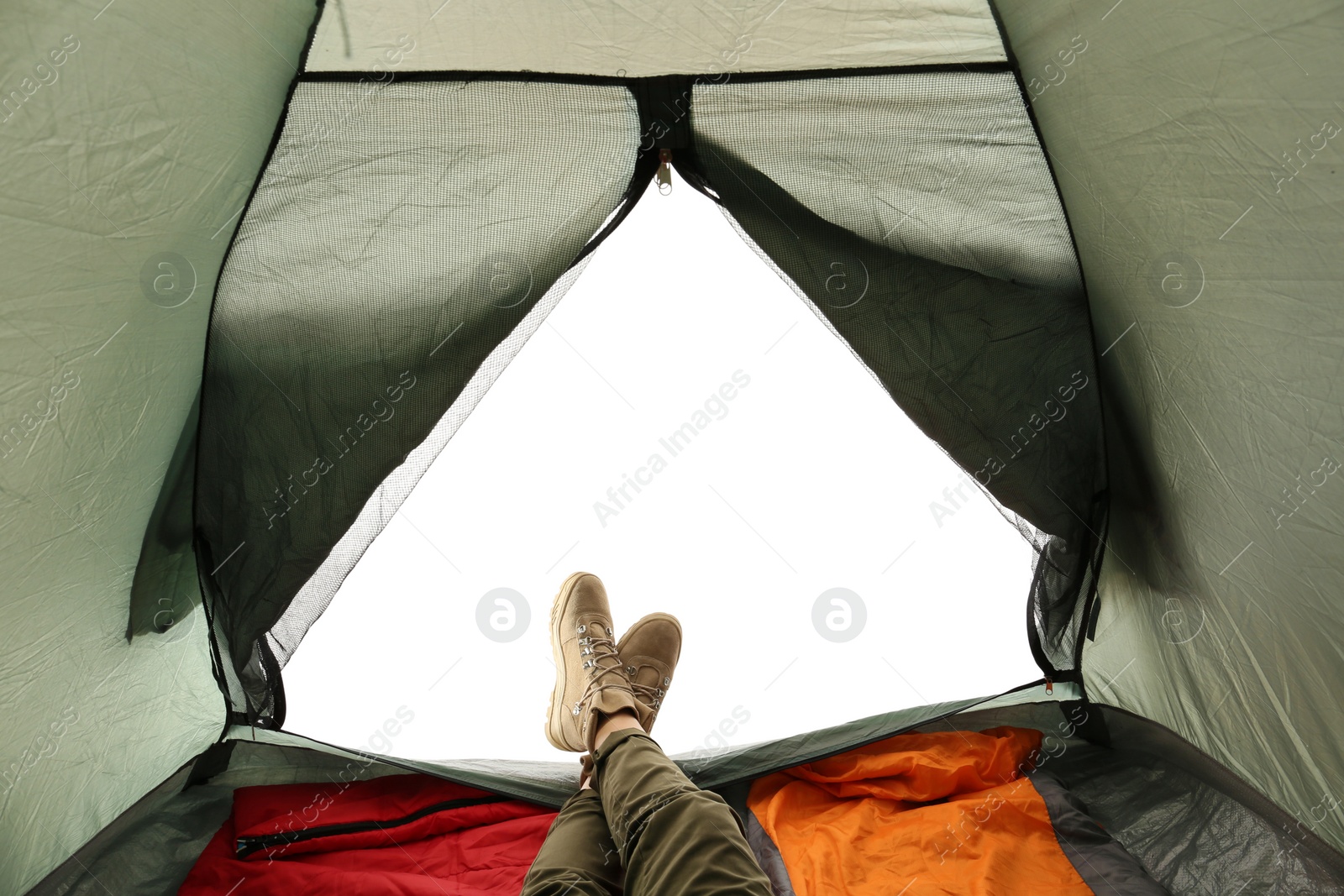 Photo of Closeup of female in camping tent on white background, view from inside