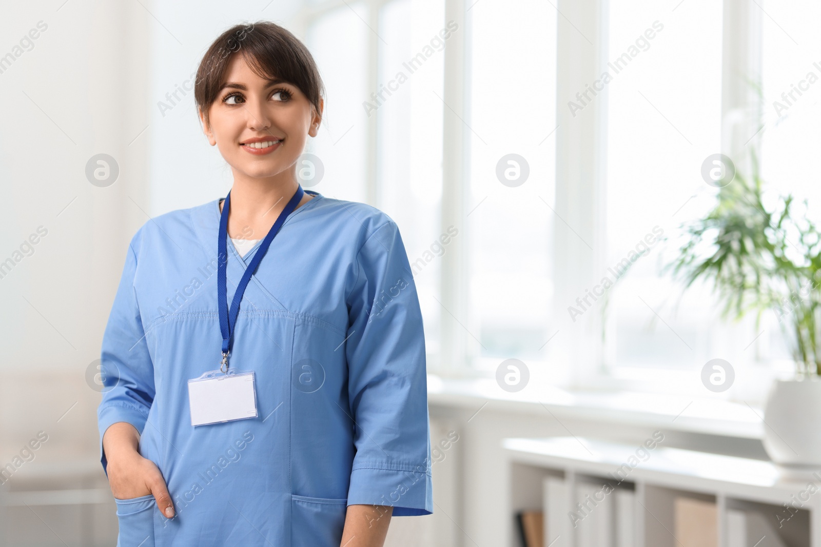 Photo of Portrait of smiling medical assistant in hospital. Space for text