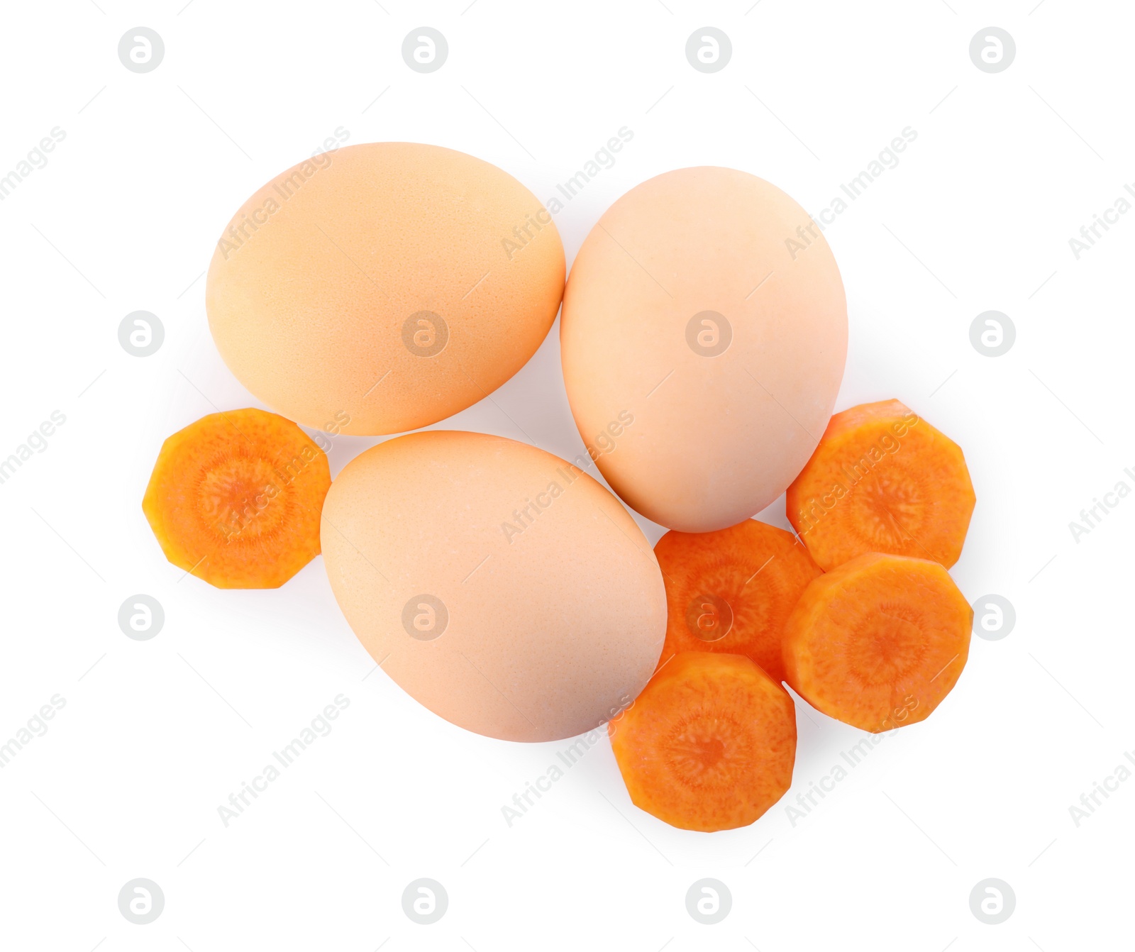 Photo of Naturally painted Easter eggs on white background, top view. Carrot used for coloring
