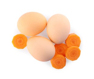 Photo of Naturally painted Easter eggs on white background, top view. Carrot used for coloring