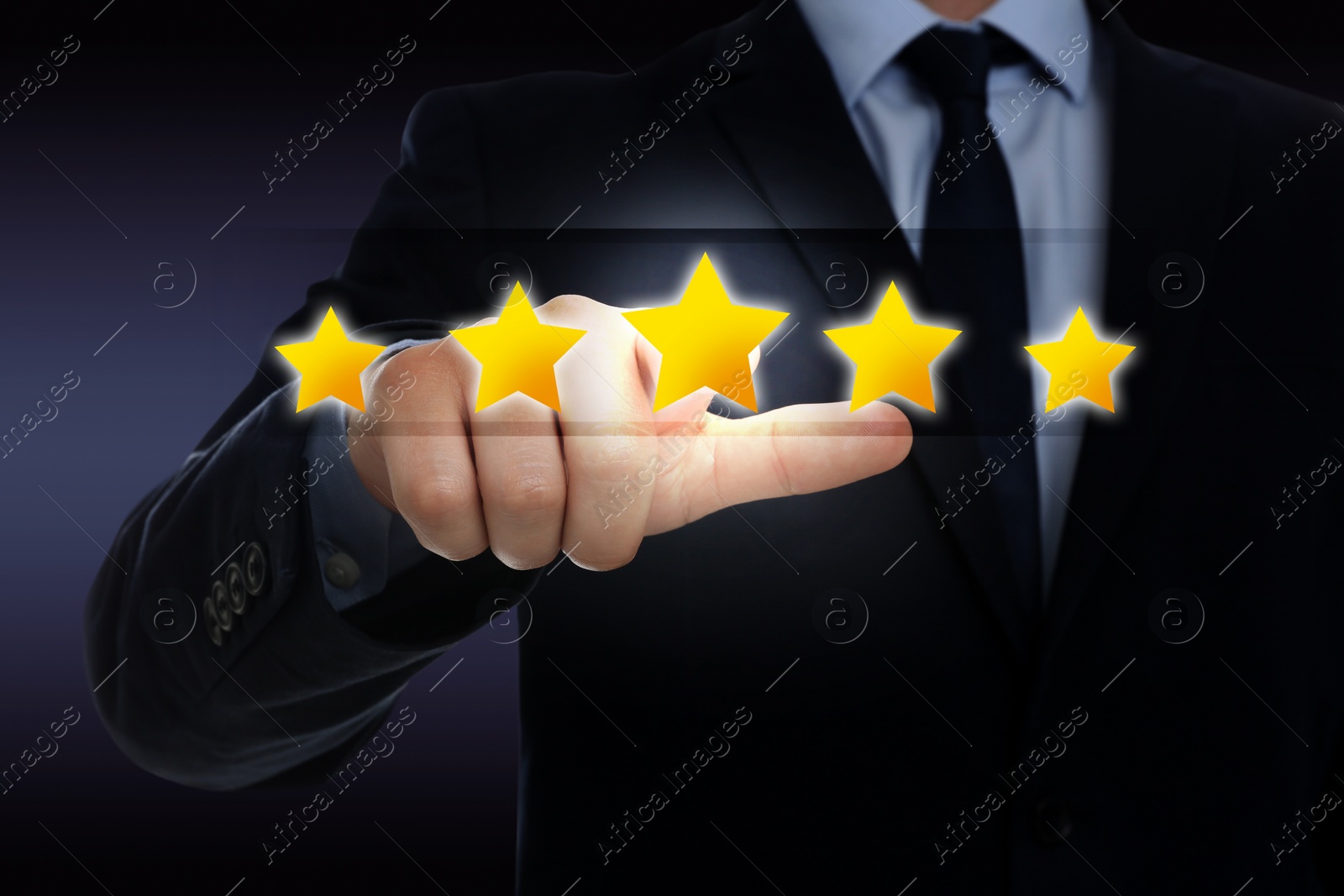 Image of Quality evaluation. Businessman touching virtual golden star on dark background, closeup