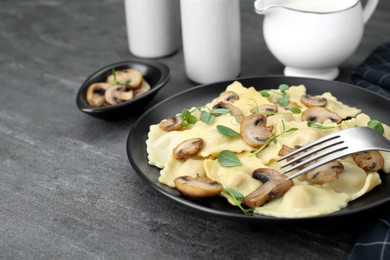 Delicious ravioli with mushrooms served on grey table, closeup