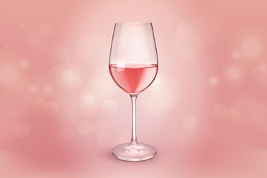 Glass of expensive rose wine on pink background