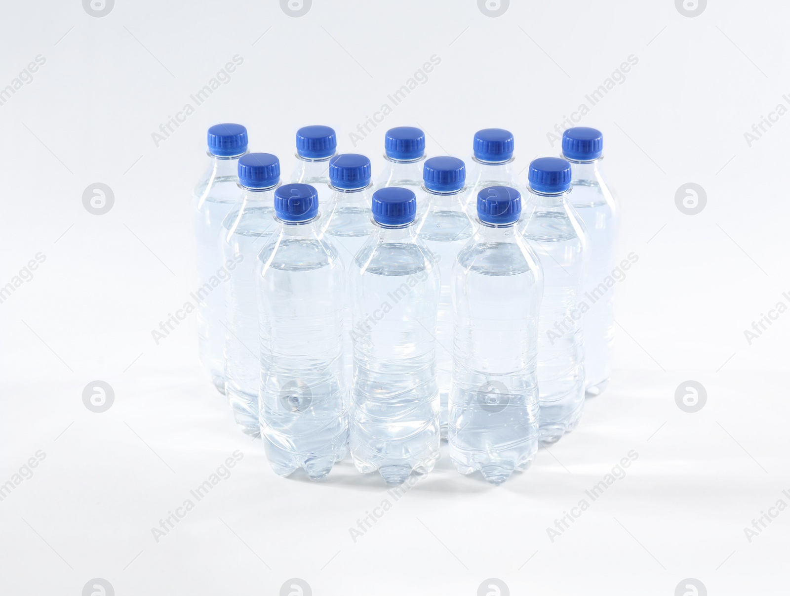 Photo of Plastic bottles with pure water on white background