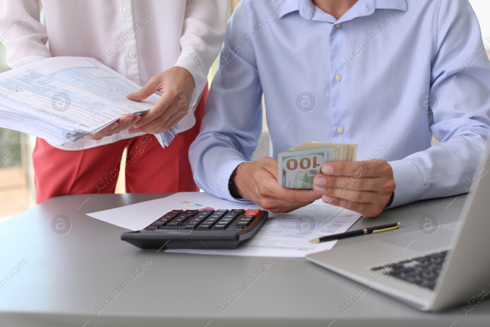 Photo of Tax accountants working with documents at table