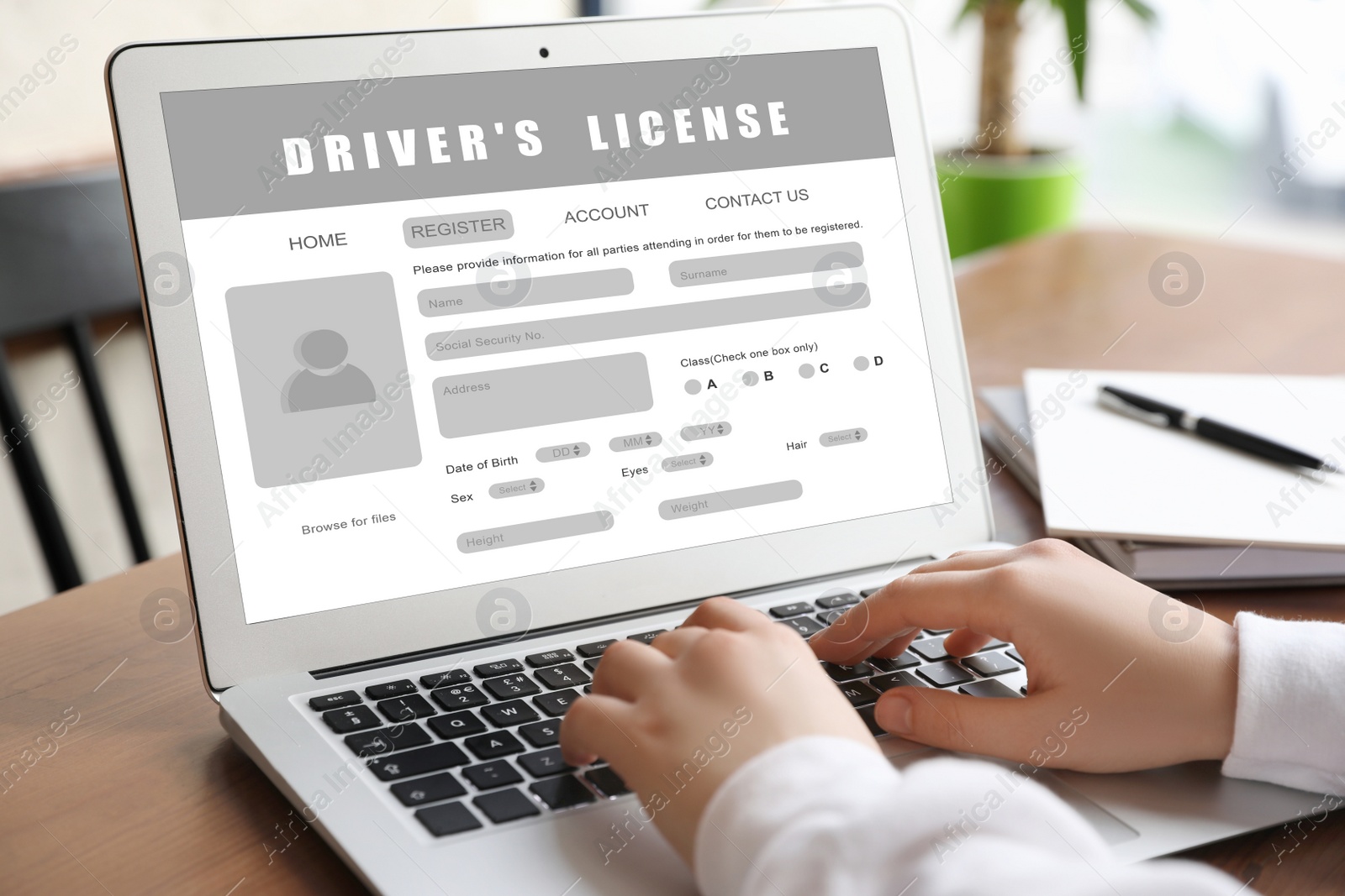 Image of Woman filling in driver's license form online on website using laptop, closeup