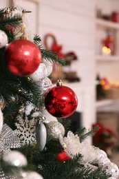 Photo of Beautiful Christmas tree with baubles in room, closeup. Interior design