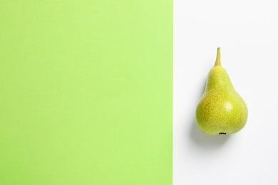 Photo of Ripe juicy pear on color background, top view